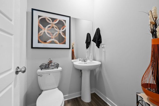 bathroom featuring hardwood / wood-style flooring and toilet