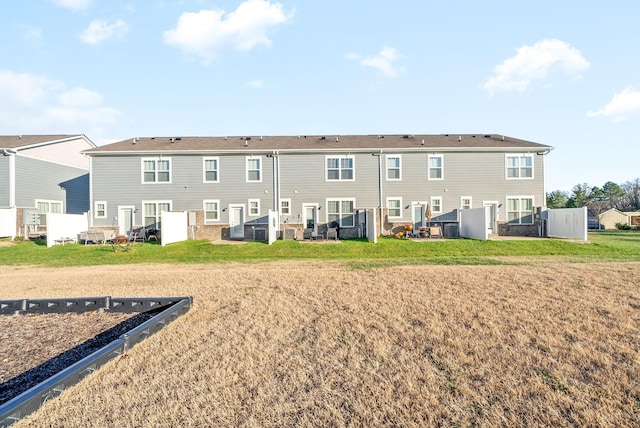 rear view of property with a lawn