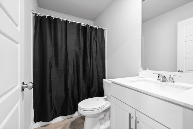 bathroom with tile patterned floors, vanity, and toilet