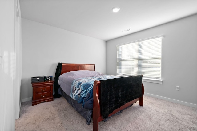 bedroom featuring light carpet