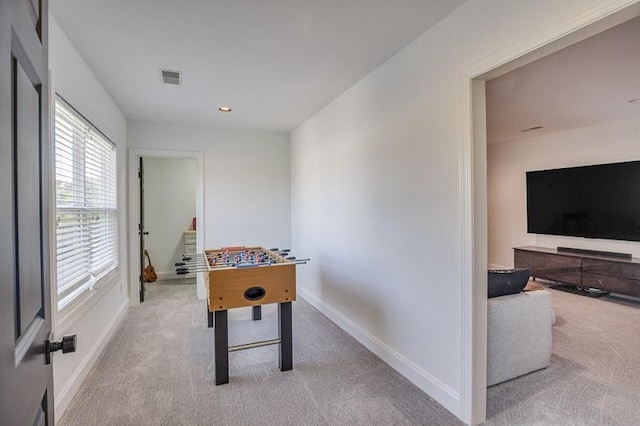 recreation room featuring light colored carpet