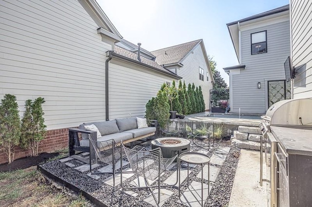 view of patio with an outdoor living space with a fire pit and an outdoor kitchen