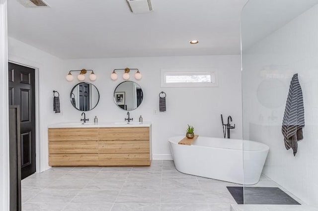 bathroom with a washtub and vanity