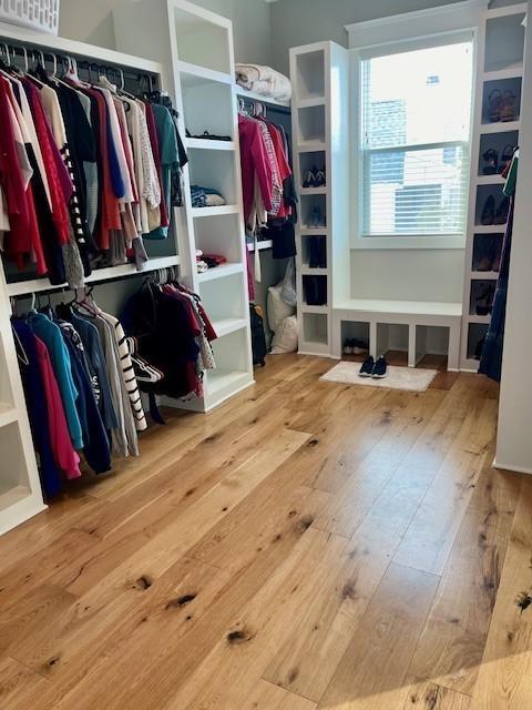 spacious closet with light hardwood / wood-style flooring