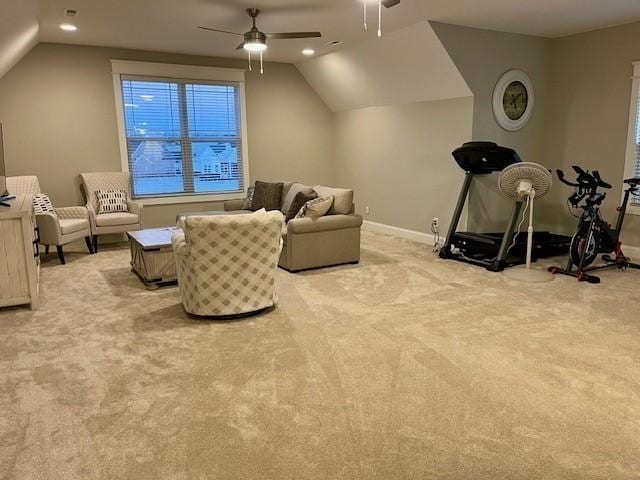 interior space featuring ceiling fan, light colored carpet, and lofted ceiling