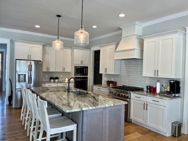 kitchen featuring white cabinetry, sink, decorative backsplash, appliances with stainless steel finishes, and custom exhaust hood