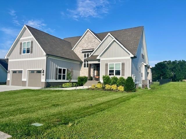 view of front of home with a front yard and a garage