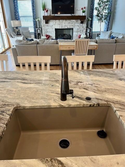 interior space with a stone fireplace and sink