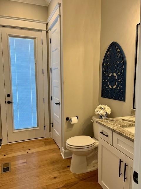 bathroom featuring vanity, toilet, and wood-type flooring