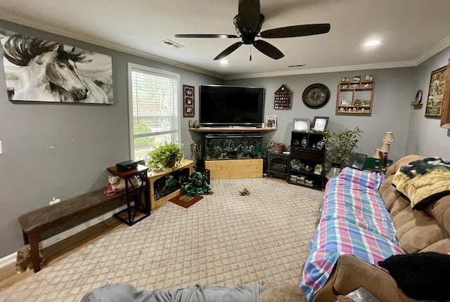 living room featuring carpet flooring, ceiling fan, and ornamental molding