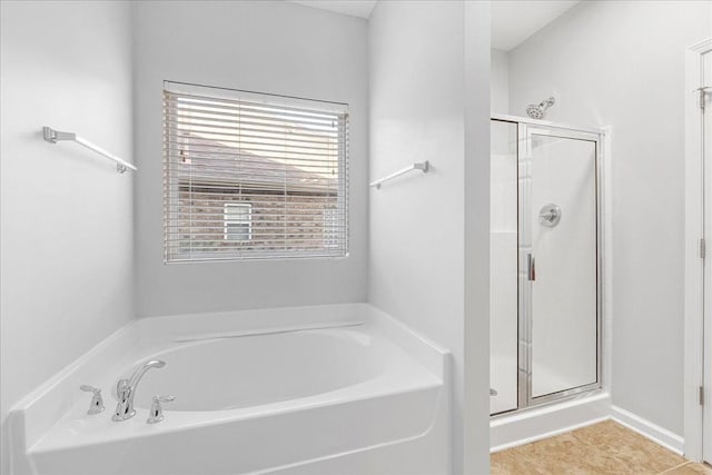 bathroom with tile patterned floors and independent shower and bath