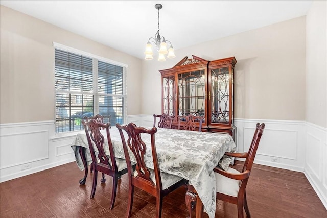 dining room featuring a notable chandelier and dark wood-type flooring