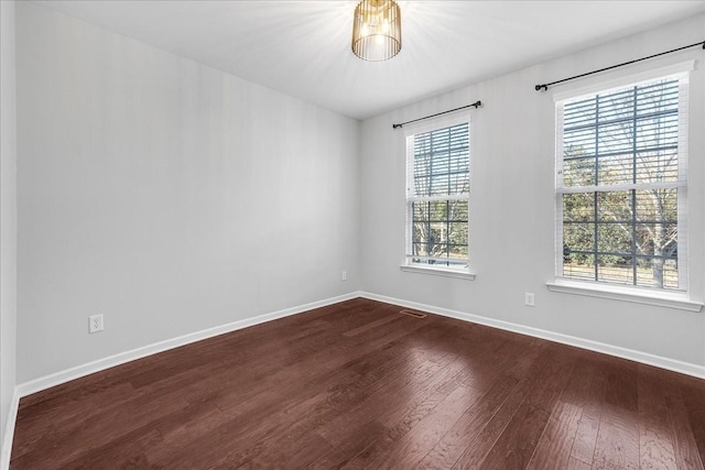 empty room featuring hardwood / wood-style flooring and a healthy amount of sunlight