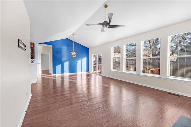 unfurnished living room with dark hardwood / wood-style flooring, vaulted ceiling, and ceiling fan