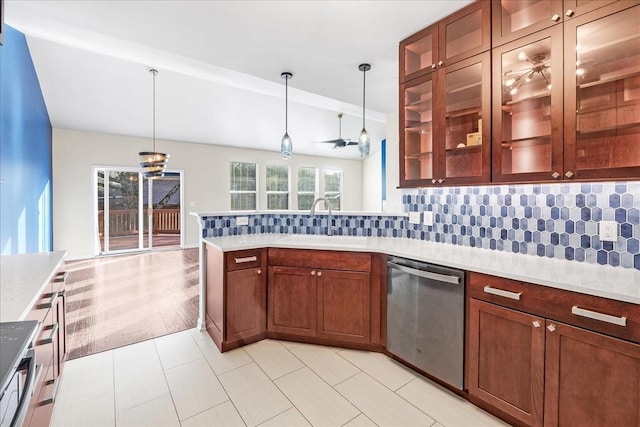 kitchen with sink, stainless steel dishwasher, ceiling fan, tasteful backsplash, and decorative light fixtures