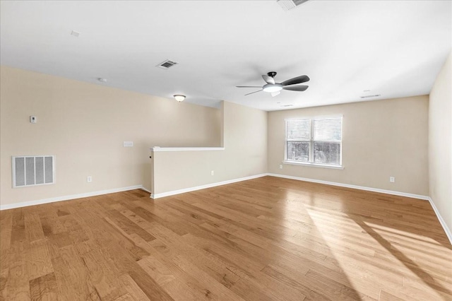 spare room with light wood-type flooring and ceiling fan