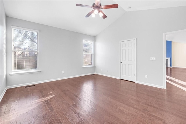 empty room with dark hardwood / wood-style floors, ceiling fan, a healthy amount of sunlight, and lofted ceiling