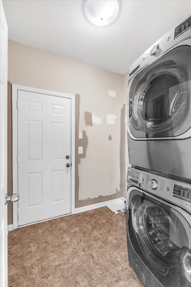 laundry room featuring stacked washer and dryer