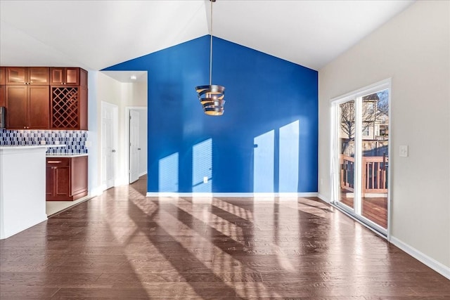 unfurnished living room with dark hardwood / wood-style floors and lofted ceiling