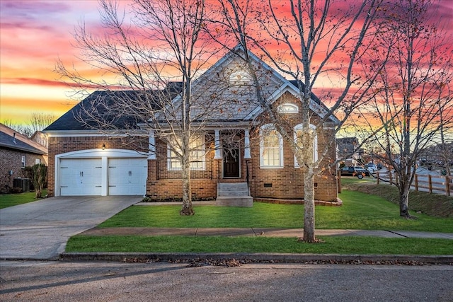 view of front of house featuring a garage and a yard