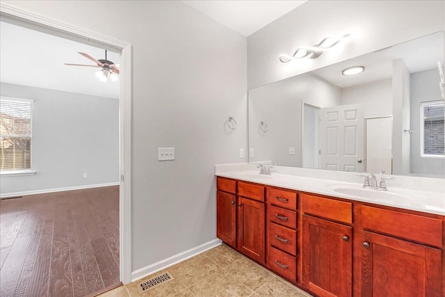 bathroom with ceiling fan and vanity