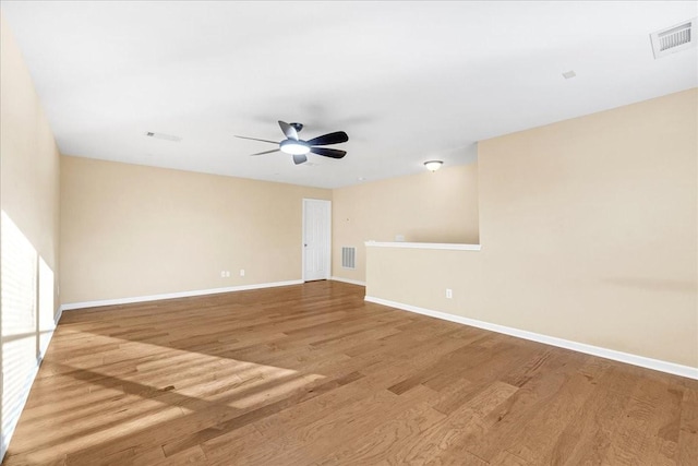 spare room with ceiling fan and light wood-type flooring