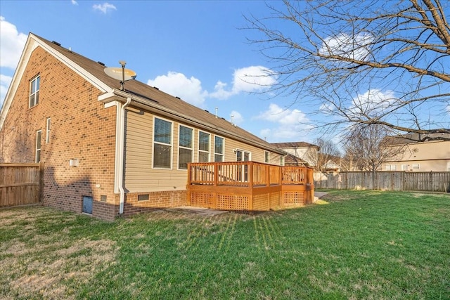 rear view of property with a lawn and a deck