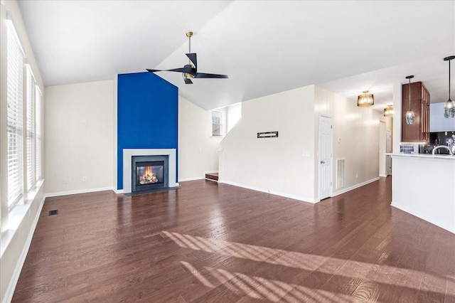 unfurnished living room with ceiling fan, dark hardwood / wood-style flooring, and lofted ceiling