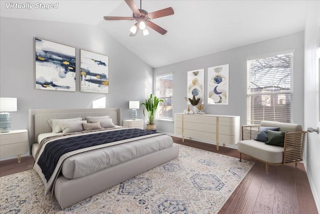 bedroom featuring wood-type flooring, vaulted ceiling, and ceiling fan