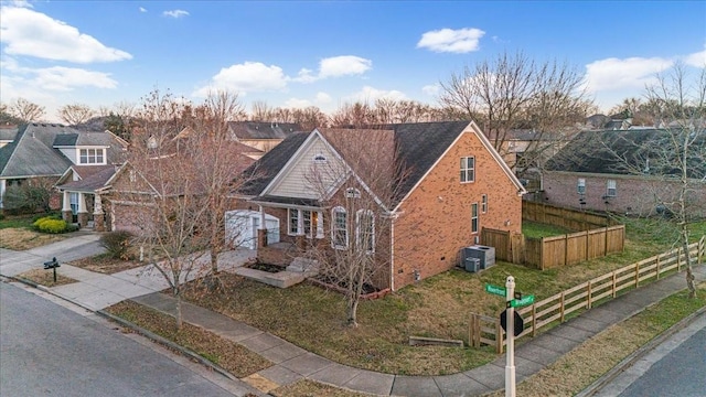 view of front of home with central air condition unit and a front yard