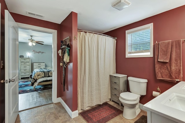 bathroom with tile patterned flooring, vanity, toilet, and ceiling fan