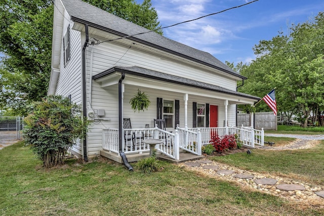 view of front of property with covered porch and a front yard