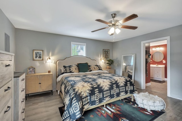 bedroom with connected bathroom, ceiling fan, sink, and light hardwood / wood-style floors