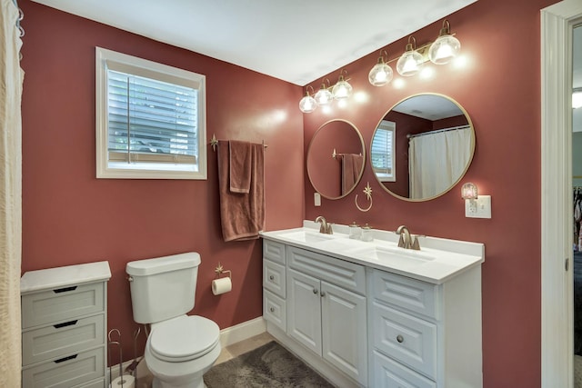 bathroom featuring tile patterned floors, vanity, curtained shower, and toilet