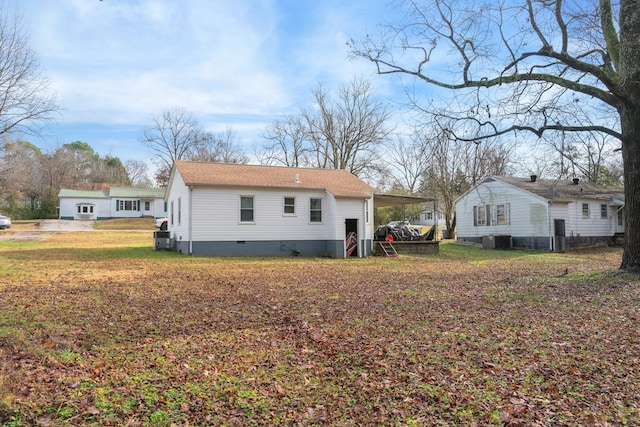 rear view of house featuring central AC unit