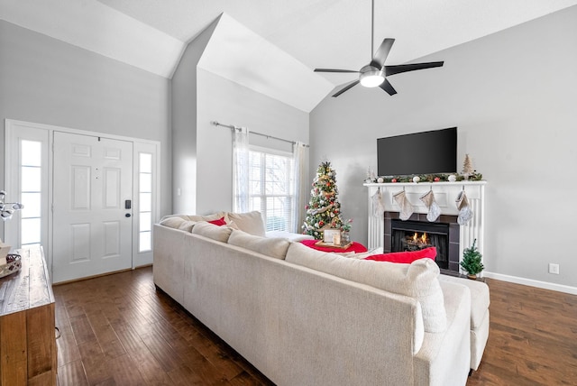 living room with a tile fireplace, ceiling fan, dark hardwood / wood-style flooring, and lofted ceiling