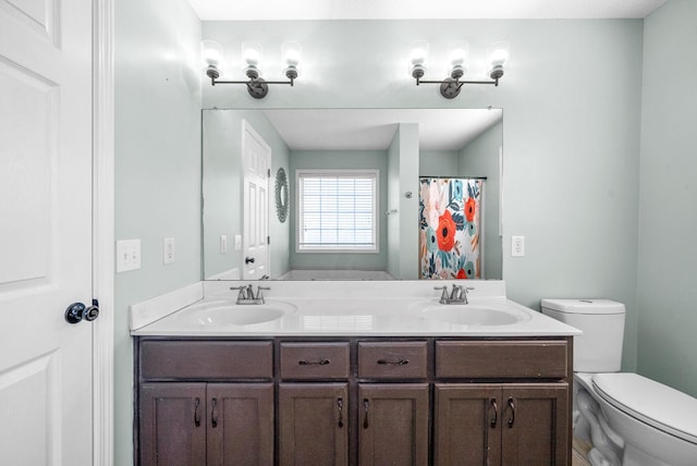 bathroom featuring vanity, toilet, and curtained shower