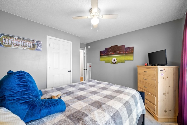 bedroom with carpet flooring, a textured ceiling, and ceiling fan