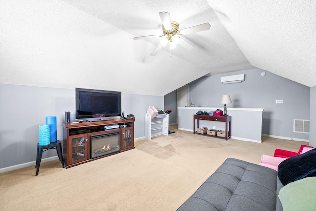 living room featuring ceiling fan, an AC wall unit, light colored carpet, a textured ceiling, and vaulted ceiling