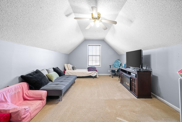 living room with a textured ceiling, ceiling fan, lofted ceiling, and light carpet