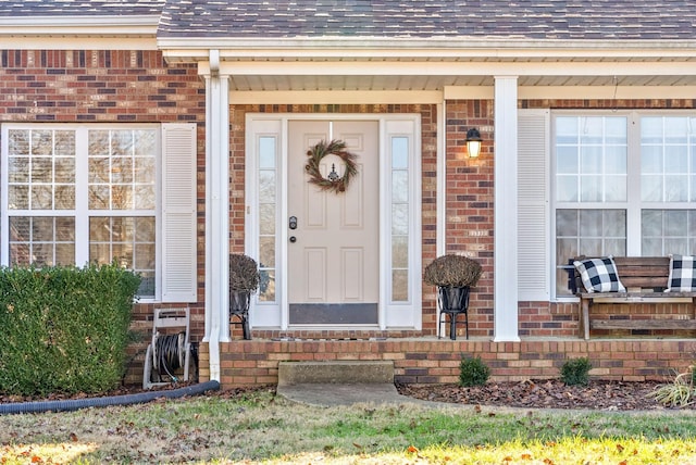 view of exterior entry featuring a porch