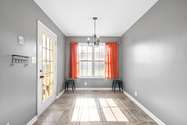 unfurnished dining area with a notable chandelier