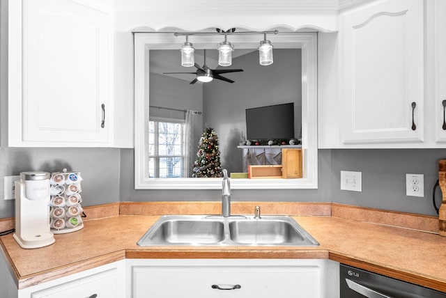 kitchen with stainless steel dishwasher, ceiling fan, white cabinets, and sink