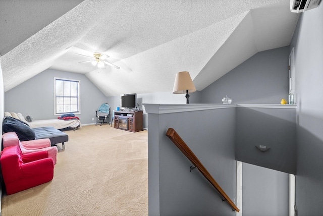 home office featuring carpet flooring, ceiling fan, a wall unit AC, a textured ceiling, and vaulted ceiling