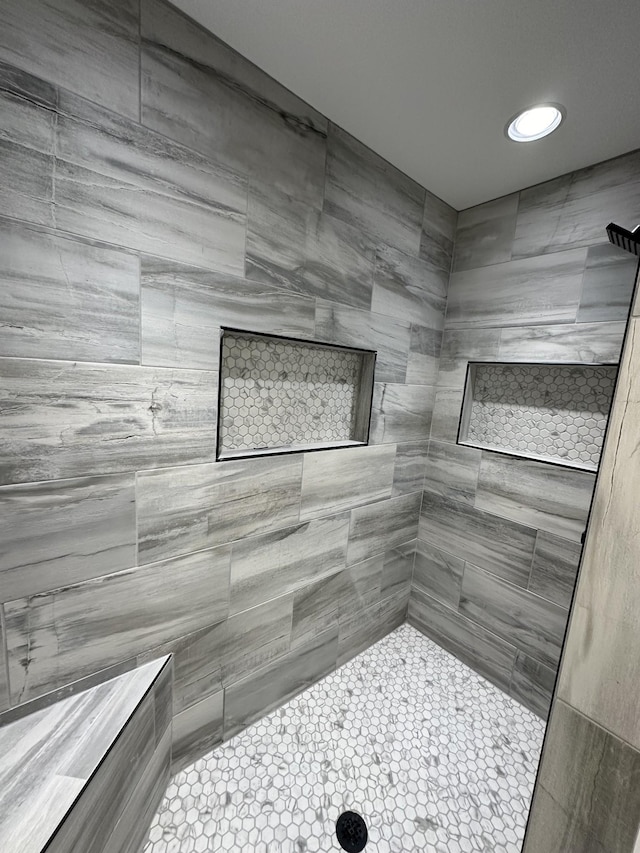 bathroom with a tile shower