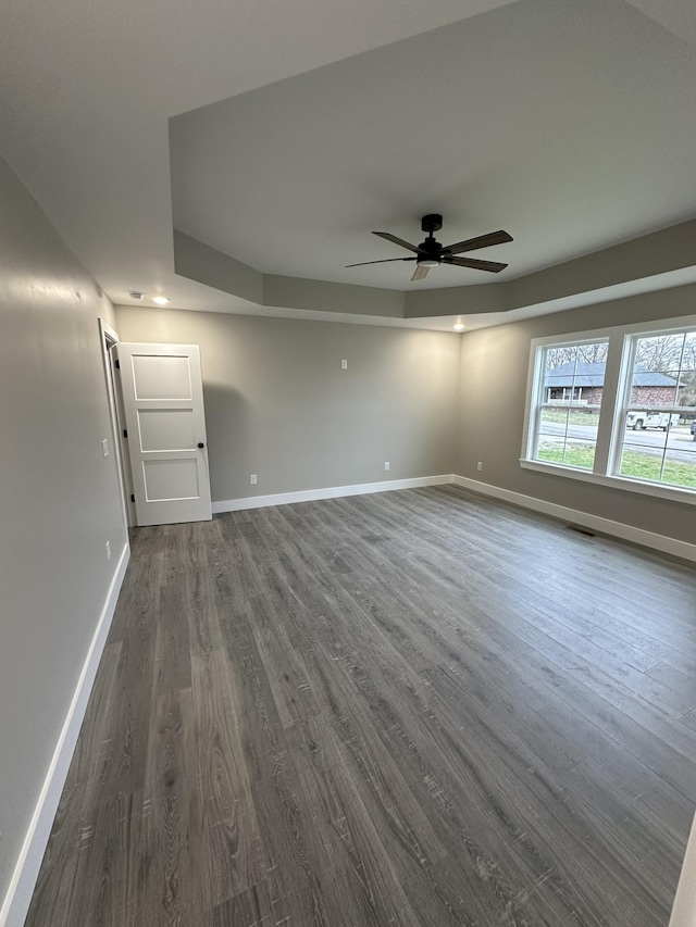 unfurnished room with ceiling fan and dark hardwood / wood-style flooring