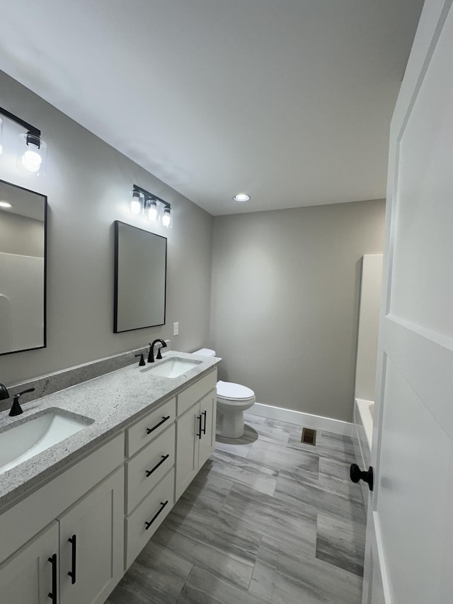 bathroom featuring vanity and toilet