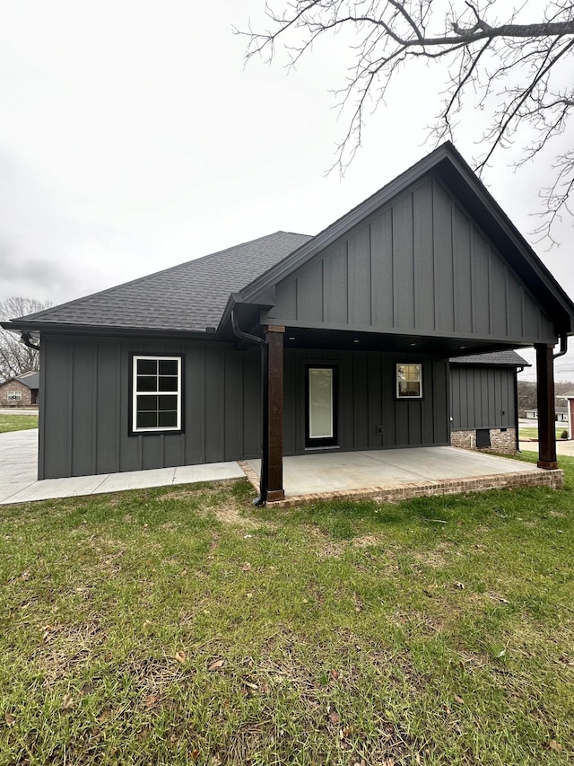 view of home's exterior with a patio area and a lawn