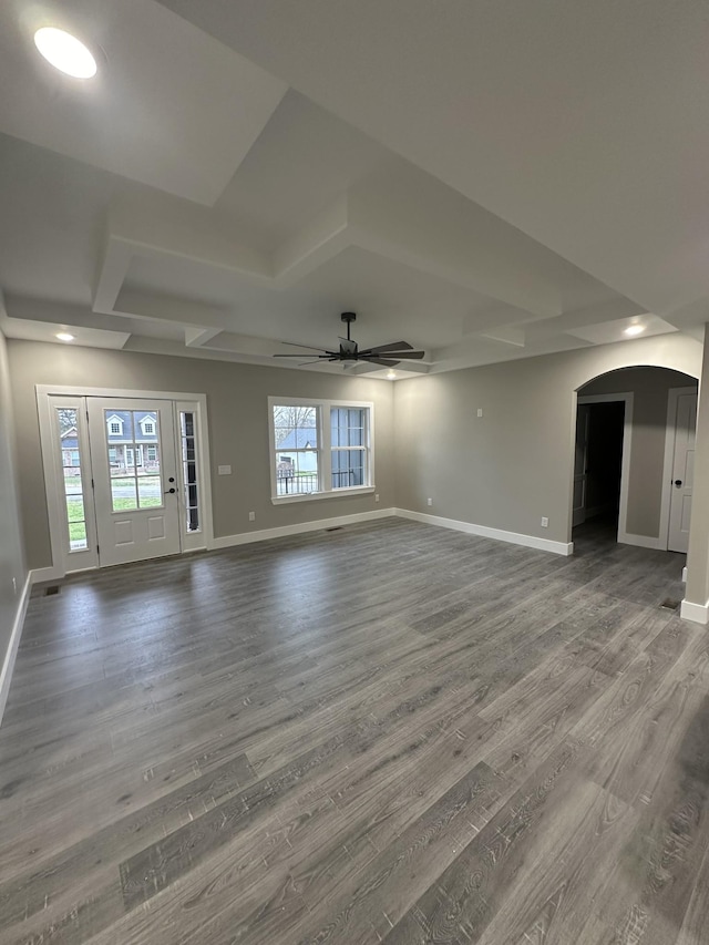 unfurnished living room with hardwood / wood-style floors, ceiling fan, and a tray ceiling