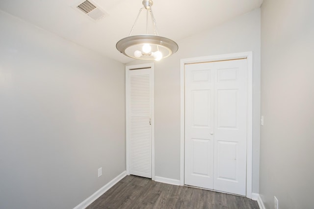 unfurnished bedroom featuring dark wood-type flooring